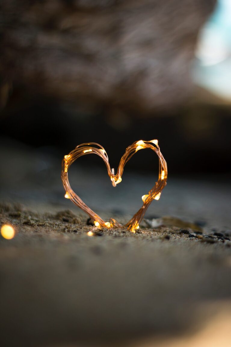 a sign of love embedded in the sands with light around it